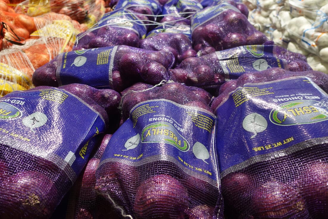 Fresh purple onions in wholesale mesh bags